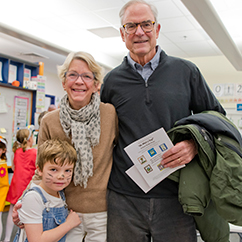 Two grandparents smiling with their grandchild. Link to Life Stage Gift Planner Over Age 65 Situations.